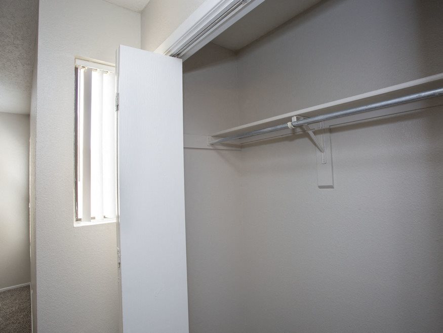A white door is open in a room with a white wall and a white ceiling.